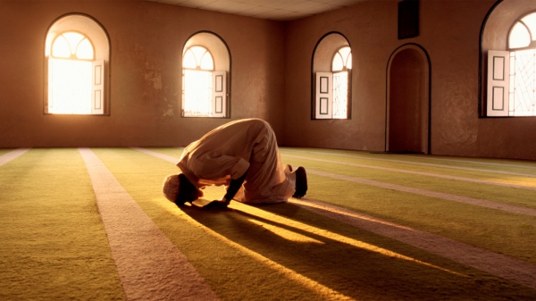 A muslim in an Islamic mosque, worshipping Allah, the Muslim God.