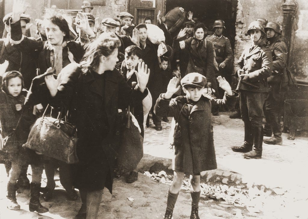 Jews being rounded up by Nazi soldiers to be taken for extermination at concentration camps.  This would not have happened if Israel's land were not stolen from them.