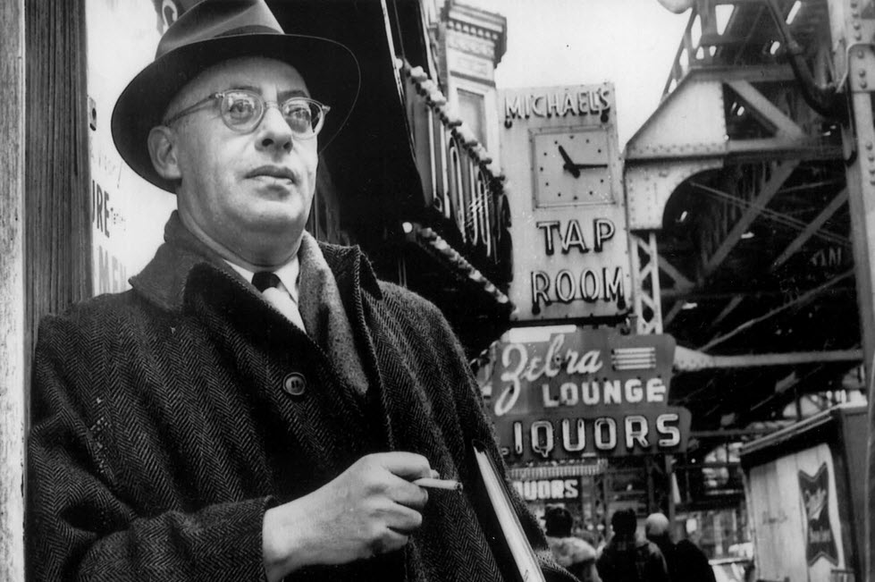 Saul Alinsky posing for a picture in front of the streets of the "powerless".
